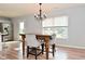Dining area with wooden table and chairs, chandelier, and window overlooking the backyard at 15524 Follow Dr, Noblesville, IN 46060