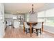 Dining area featuring a wood table, upholstered chairs, chandelier, and view to kitchen at 15524 Follow Dr, Noblesville, IN 46060