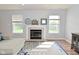 Close-up of the fireplace with decorative mantel, flanked by windows in the living room at 15524 Follow Dr, Noblesville, IN 46060