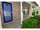 Close up of a home's entry way with brick facade, a blue door, and manicured shrubbery at 15524 Follow Dr, Noblesville, IN 46060
