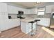 Well-lit kitchen with white cabinets, stainless steel appliances, and central island with seating at 15524 Follow Dr, Noblesville, IN 46060