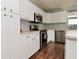Kitchen with stainless steel appliances, white cabinets, and wood-look flooring at 15524 Follow Dr, Noblesville, IN 46060