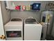 Functional laundry room equipped with washer, dryer, shelving, and utility connections at 15524 Follow Dr, Noblesville, IN 46060