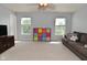 Bright living room featuring a comfortable sofa, a TV, and colorful storage at 15524 Follow Dr, Noblesville, IN 46060
