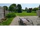 Relaxing patio with a lounge chair overlooking the fenced-in yard and mature trees at 15524 Follow Dr, Noblesville, IN 46060