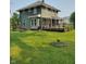 The backyard features a green lawn, a porch and an inground firepit at 1617 Blaine Ave, Terre Haute, IN 47804
