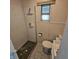 Bathroom featuring a shower stall, toilet, window and sink at 1617 Blaine Ave, Terre Haute, IN 47804