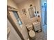 A bathroom featuring a toilet, sink, cabinet, mirror, and a window at 1617 Blaine Ave, Terre Haute, IN 47804