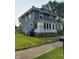 Well-maintained two-story home with a green exterior, white accents, and a spacious yard at 1617 Blaine Ave, Terre Haute, IN 47804