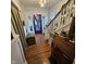Inviting foyer with staircase and hardwood floors, creating a warm first impression at 1617 Blaine Ave, Terre Haute, IN 47804