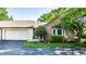 Charming brick home with attached garage and well-manicured front yard landscaping at 1663 Cloister Dr, Indianapolis, IN 46260
