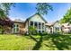 Rear exterior of the home showcasing a screened porch and manicured lawn at 1663 Cloister Dr, Indianapolis, IN 46260