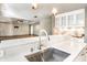 Bright kitchen featuring modern countertops, stainless sink, and open access to the living area at 1663 Cloister Dr, Indianapolis, IN 46260