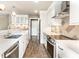 Well-lit kitchen showcasing updated cabinetry, stainless appliances, and sleek countertops at 1663 Cloister Dr, Indianapolis, IN 46260