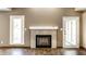 Living room showcasing a decorative fireplace and view of the backyard at 1663 Cloister Dr, Indianapolis, IN 46260