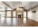 Spacious living area featuring vaulted ceilings, hardwood floors, and a modern fireplace at 1663 Cloister Dr, Indianapolis, IN 46260