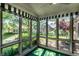 Bright sunroom featuring large windows with beautiful views of the landscaped backyard and pond at 1663 Cloister Dr, Indianapolis, IN 46260