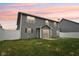 Back exterior of home featuring a sliding glass door, lawn, and privacy fence at 1739 Wedgewood Pl, Avon, IN 46123