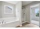 Bright bathroom showcasing soaking tub and a shower featuring a sliding glass door at 1739 Wedgewood Pl, Avon, IN 46123