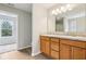 Bathroom featuring wood cabinets, double sinks, granite countertop, and a walk-in shower at 1739 Wedgewood Pl, Avon, IN 46123