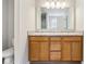 Bright bathroom with double sink vanity, granite countertop, wood cabinetry, and toilet at 1739 Wedgewood Pl, Avon, IN 46123