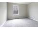 A carpeted bedroom features neutral walls and a window providing natural light at 1739 Wedgewood Pl, Avon, IN 46123
