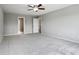 Spacious bedroom with neutral gray walls, plush carpet, and a modern ceiling fan at 1739 Wedgewood Pl, Avon, IN 46123