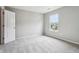 Bright bedroom with carpet, neutral walls, a window, and a white door leading to the closet at 1739 Wedgewood Pl, Avon, IN 46123