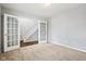 Carpeted bedroom featuring glass french doors that lead to the staircase at 1739 Wedgewood Pl, Avon, IN 46123