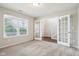 Carpeted bedroom featuring a large window and glass french doors leading to the hallway at 1739 Wedgewood Pl, Avon, IN 46123
