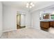 Dining room with carpet, a window, and views to the kitchen and entry with tile flooring at 1739 Wedgewood Pl, Avon, IN 46123