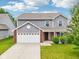 Charming two-story home with a well-manicured lawn, brick accents, and an attached two-car garage at 1739 Wedgewood Pl, Avon, IN 46123