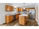 Kitchen with granite counters, stainless steel appliances, island, and tile flooring at 1739 Wedgewood Pl, Avon, IN 46123