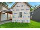 Exterior view of home featuring protective builder's wrap, a window, and a tidy lawn at 1917 Union St, Indianapolis, IN 46225