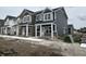 New two story townhome with horizontal siding, covered entry, and concrete sidewalk at 19541 Grassy Branch Rd, Westfield, IN 46074