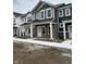 View of new townhomes featuring stone accents, covered porches, and horizontal siding at 19541 Grassy Branch Rd, Westfield, IN 46074