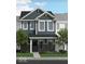 Charming two-story townhome with blue siding and stone accents with landscaped front yard at 19541 Grassy Branch Rd, Westfield, IN 46074