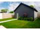 Beautiful backyard featuring a well maintained lawn and a dark gray garage at 2014 W Michigan St, Indianapolis, IN 46222