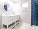 Modern bathroom with a dual sink vanity, oval mirrors, and blue accent tiles at 2014 W Michigan St, Indianapolis, IN 46222