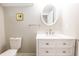 Bathroom with a white vanity, an oval mirror, and a toilet at 2014 W Michigan St, Indianapolis, IN 46222