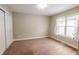 Bright empty bedroom featuring carpeted floors, a window, and closet at 2014 W Michigan St, Indianapolis, IN 46222