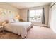 Bright bedroom featuring neutral walls, a cozy bed, and natural light from the window at 2014 W Michigan St, Indianapolis, IN 46222