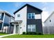 Attractive two-story home featuring a modern two-tone design and a lush green lawn at 2014 W Michigan St, Indianapolis, IN 46222