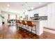 Modern kitchen with an island featuring barstool seating and views of the dining area at 2014 W Michigan St, Indianapolis, IN 46222
