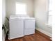 Bright laundry room with hardwood floors featuring modern washer and dryer at 2014 W Michigan St, Indianapolis, IN 46222