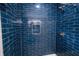 Modern shower featuring a shower head and blue tiling at 2014 W Michigan St, Indianapolis, IN 46222