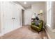 Sitting area with a green chair, bookshelf, and multiple doors at 2014 W Michigan St, Indianapolis, IN 46222