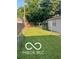 Fenced backyard with ample grass and clothes line at 2028 Gilmore St, Columbus, IN 47201