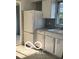 Kitchen featuring white cabinets, laminate countertop, and stainless steel sink at 2028 Gilmore St, Columbus, IN 47201