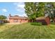 Expansive backyard featuring a well-maintained lawn, brick house, shed, and ample space for outdoor activities at 206 Banbury Rd, Noblesville, IN 46062